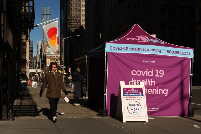 A woman walks past a COVID-19 testing site on 5th Avenue on Jan. 16, 2022.